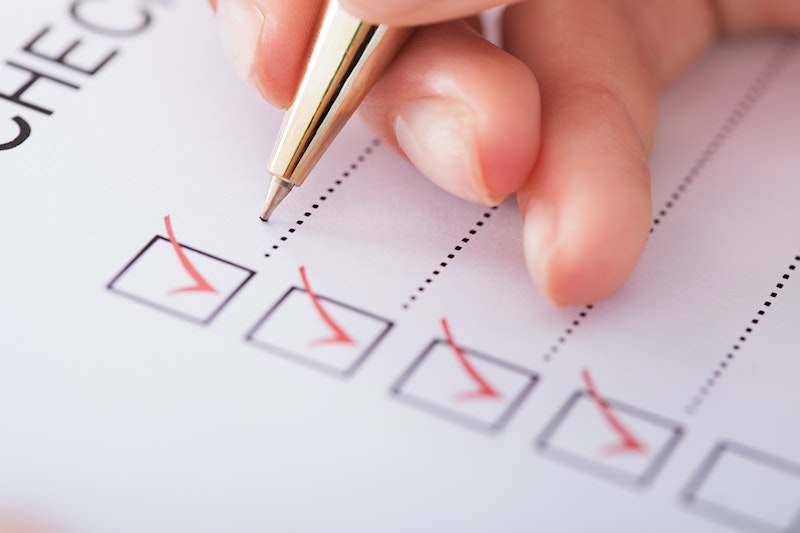 Checking off items on a pre-operative checklist for breast augmentation.
