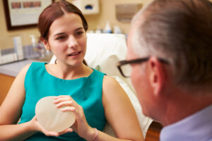 Patient discusses recovery steps for breast augmentation with surgeon.