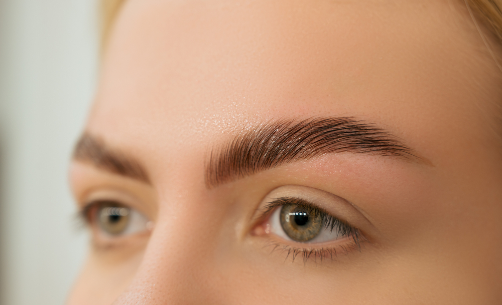  Detailed view of a woman's healed eyebrows post-direct brow lift surgery.