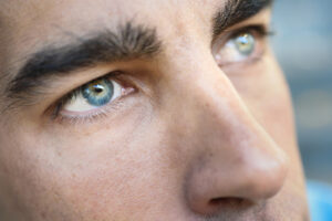 Close-up of a man's eyes, showcasing potential results of tailored masculine brow lift surgery.
