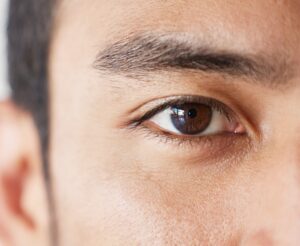Close-up of a man's eye, showcasing potential eyelid surgery results.