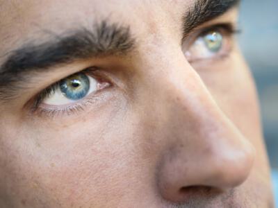 Close-up of a man's eyes, showcasing potential results of tailored masculine brow lift surgery.