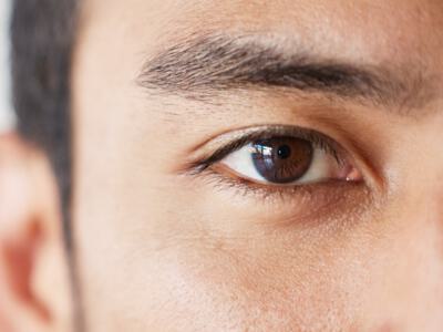 Close-up of a man's eye, showcasing potential eyelid surgery results.