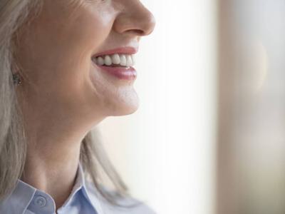 Close up to the lower face of a mature patient who had a chin implant procedure and is now recovering.